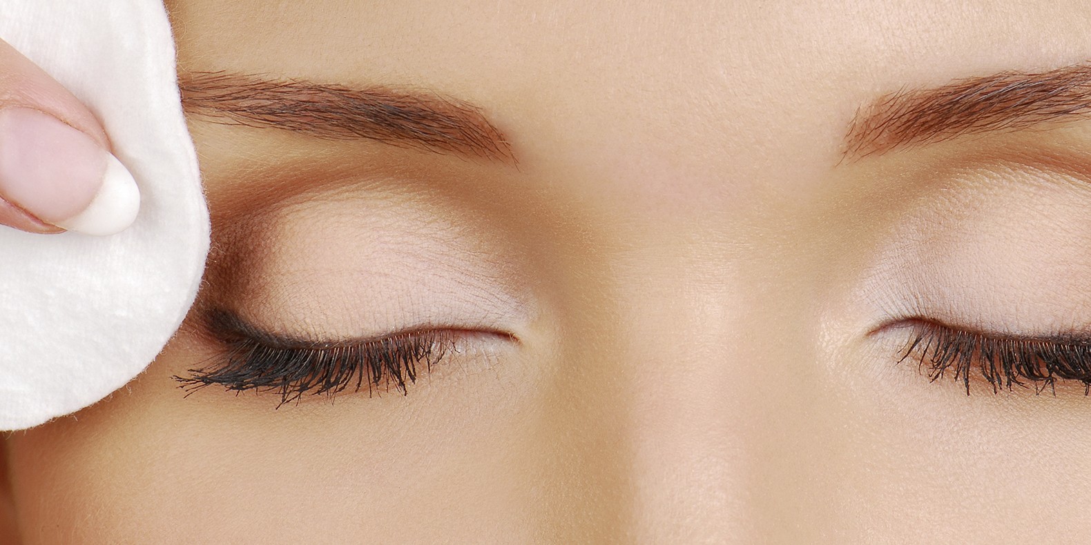 —leaning woman face with cotton pads. Cosmetic treatment.