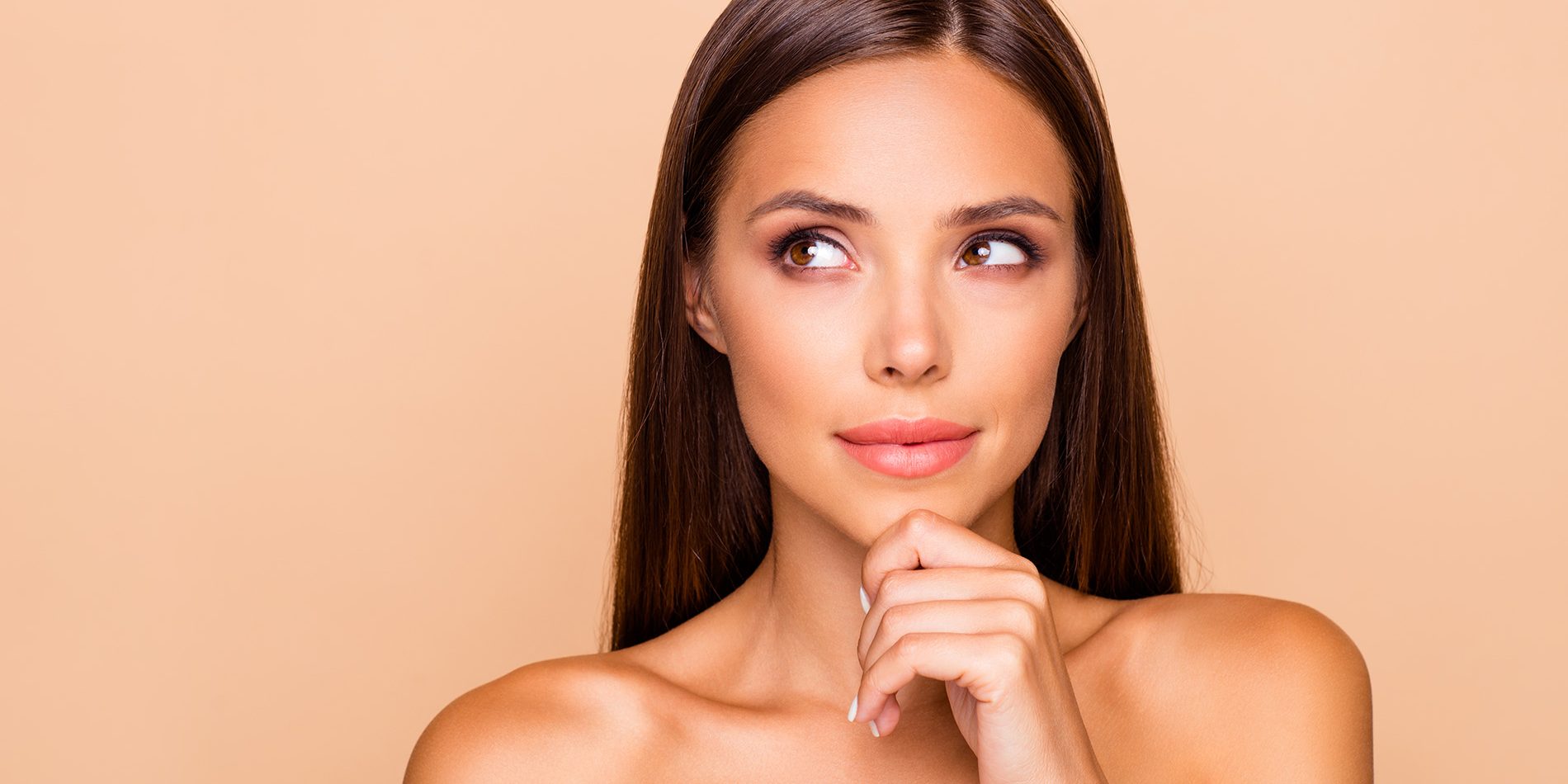 Close up photo of cute nice sweet lovely pretty lady with her shoulders she isolated on pastel beige background with copy space for text look aside hold chin by hand